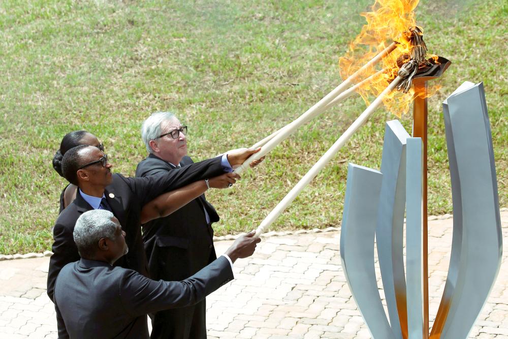 


African Union Commission Chairperson Moussa Faki Mahamat, Rwandan President Paul Kagame, Jeannette Kagame and European Commission President Jean-Claude Juncker, light the flame of hope during a commemoration ceremony of the 25th anniversary of the genocide at the Genocide Memorial in Gisozi in Kigali, Rwanda on Sunday. — Reuters