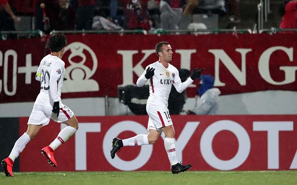 Kashima Antlers’ Serginho (R) celebrates his goal against Gyeongnam FC during the AFC Champions League Group E match in Changwon, South Korea, Tuesday. — AFP 