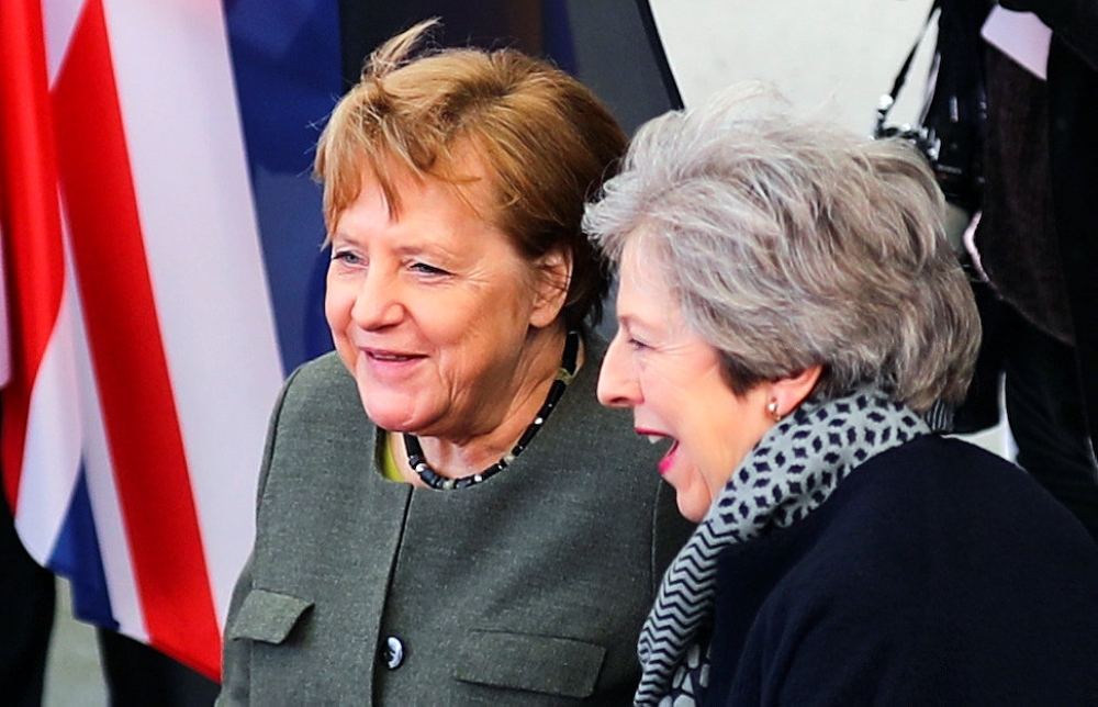 British Prime Minister Theresa May is welcomed by German Chancellor Angela Merkel, as they meet to discuss Brexit, at the chancellery in Berlin, Germany, on Tuesday. — Reuters