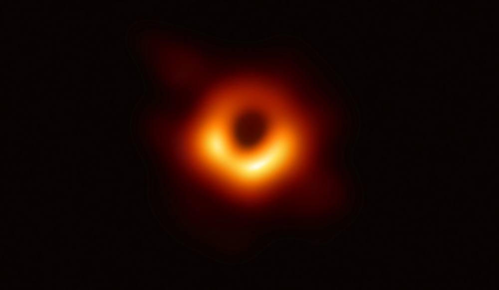 The first ever photo a black hole, taken using a global network of telescopes, conducted by the Event Horizon Telescope (EHT) project, to gain insight into celestial objects with gravitational fields so strong no mater or light can escape, is shown in this handout photo released on Wednesday. — Reuters