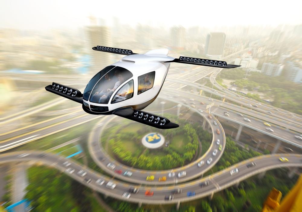 


Artistic rendering of an electric vertical takeoff and landing taxi cruising through an urban center. — Courtesy photo