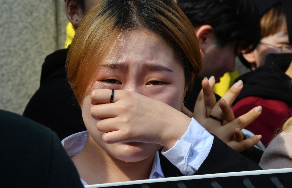 South Korean women’s rights activists react after the constitutional court’s ruling on decriminalization of abortion during a rally against the abortion ban outside the court in Seoul on Thursday. — AFP