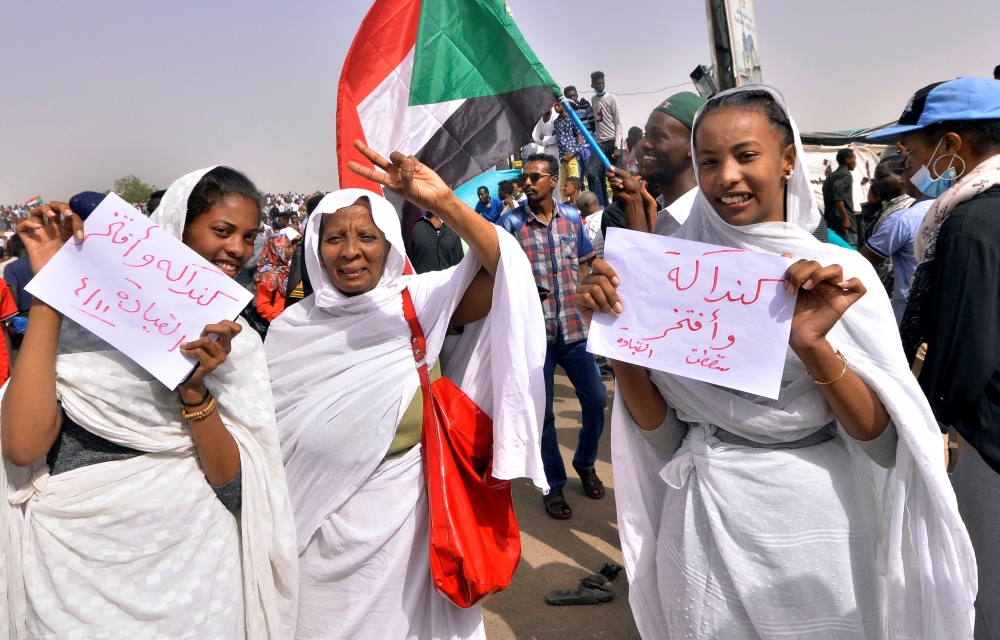Sudanese demonstrators chant slogans along the streets after Sudan’s Defense Minister Awad Mohamed Ahmed Ibn Auf said that President Omar Bashir had been detained “in a safe place” and that a military council would run the country for a two-year transitional period in Khartoum, Sudan, on Thursday. — Reuters