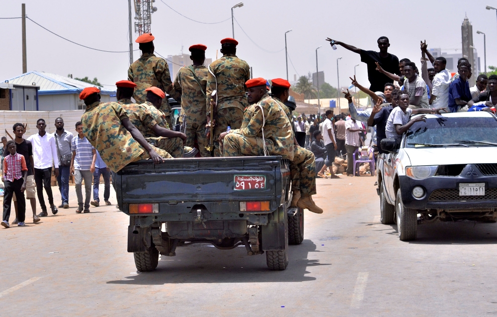 Sudanese demonstrators chant slogans along the streets after Sudan’s Defense Minister Awad Mohamed Ahmed Ibn Auf said that President Omar Bashir had been detained “in a safe place” and that a military council would run the country for a two-year transitional period in Khartoum, Sudan, on Thursday. — Reuters