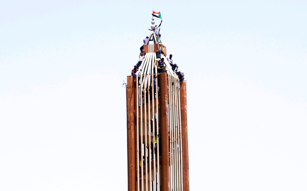 Sudanese demonstrators chant slogans along the streets after Sudan’s Defense Minister Awad Mohamed Ahmed Ibn Auf said that President Omar Bashir had been detained “in a safe place” and that a military council would run the country for a two-year transitional period in Khartoum, Sudan, on Thursday. — Reuters