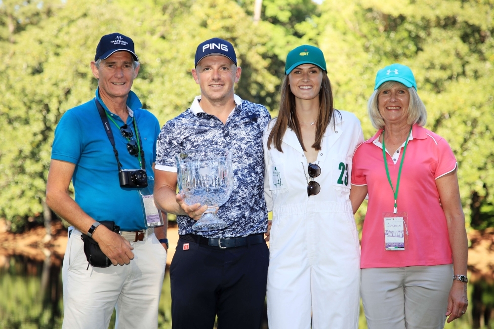 Par 3 champion Matt Wallace of England poses with girlfriend Chelsie Joce, parents and the trophy after winning the Par 3 Contest prior to the Masters at Augusta National Golf Club on Wednesday in Augusta, Georgia. — AFP