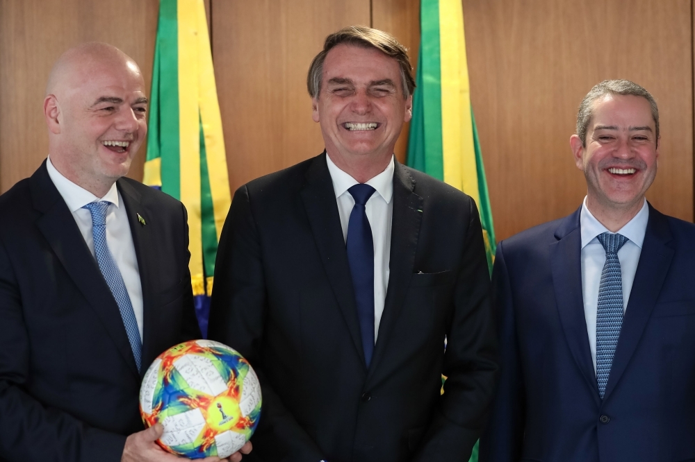 Handout picture released by Brazilian Presidency showing Brazilian President Jair Bolsonaro (C), FIFA President Gianni Infantino (L) and Brazilian Football Confederation (CBF) President Rogerio Caboclo posing during a meeting at Planalto Palace in Brasilia, on Wednesday. — AFP