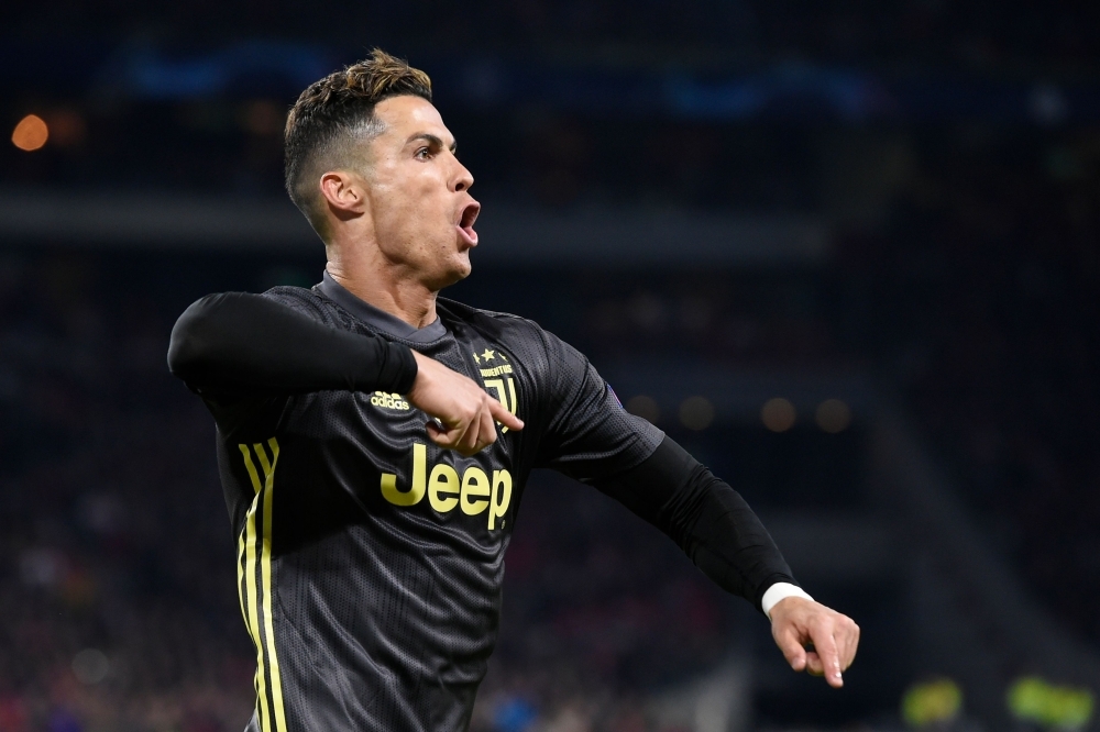 Juventus' Portuguese forward Cristiano Ronaldo celebrates   after scoring a goal  during the UEFA Champions League first leg quarter-final football match between Ajax Amsterdam and Juventus FC at the Johan Cruijff ArenA in Amsterdam on Wednesday — AFP