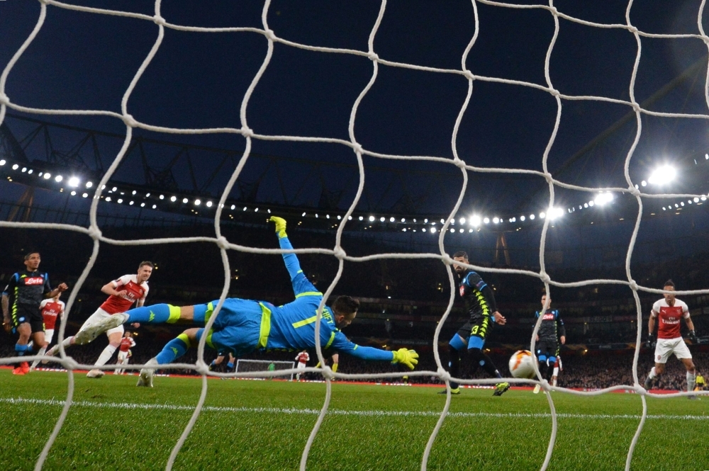 Arsenal's Welsh midfielder Aaron Ramsey scores the team's first goal during the UEFA Europa League quarterfinal, first leg, football match against Napoli at the Emirates Stadium in London on Thursday. — AFP