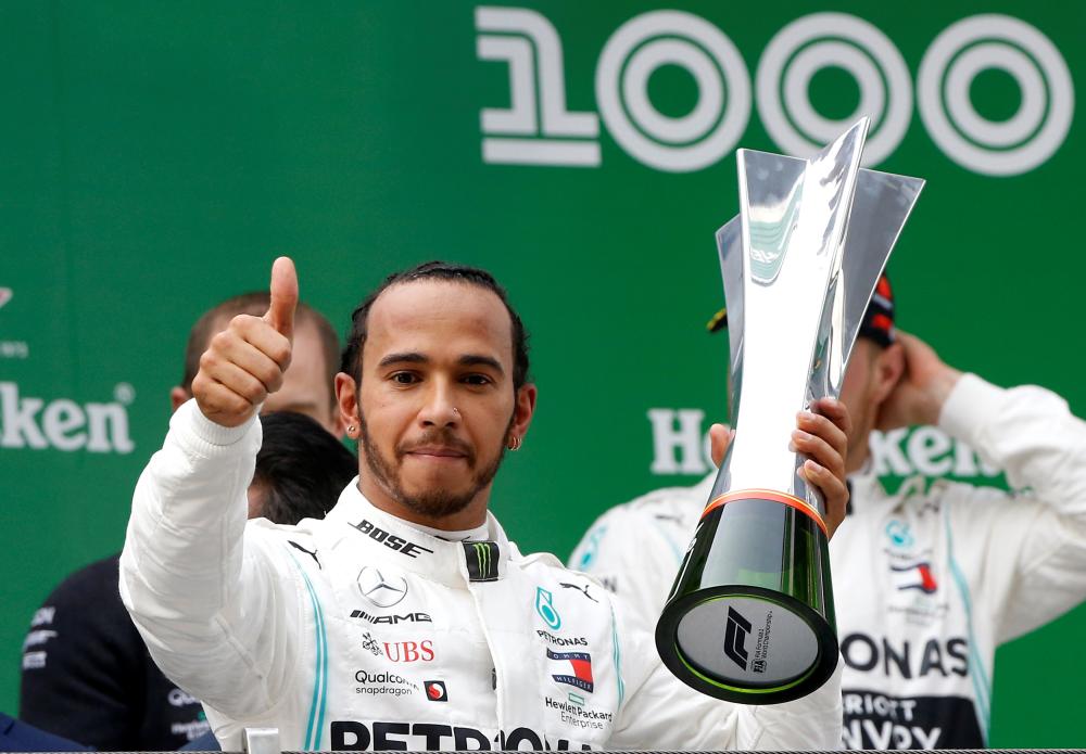 Mercedes’ Lewis Hamilton celebrates winning the Chinese Grand Prix at Shanghai International Circuit Sunday. — Reuters