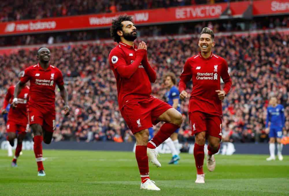 Liverpool's Mohamed Salah celebrates scoring their second goal against Chelsea during their Premier League match at Anfield Sunday. — Reuters