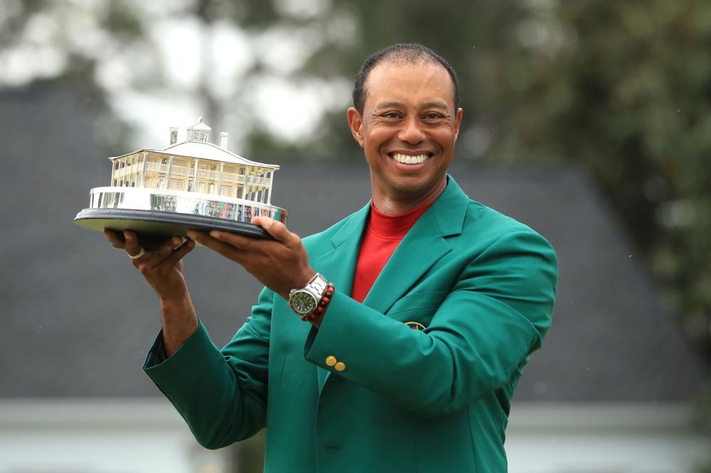 Tiger Woods of the US celebrates with the Masters Trophy during the Green Jacket Ceremony after winning the Masters at Augusta National Golf Club in Augusta, Georgia, Sunday. — AFP 