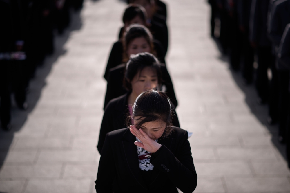 A woman wiper her eyes as she waits to pay her respects before the statues of late North Korean leaders Kim Il Sung and Kim Jong Il, as part of celebrations marking the anniversary of the birth of Kim Il Sung, known as the ‘Day of the Sun’, on Mansu hill in Pyongyang on Monday. — AFP