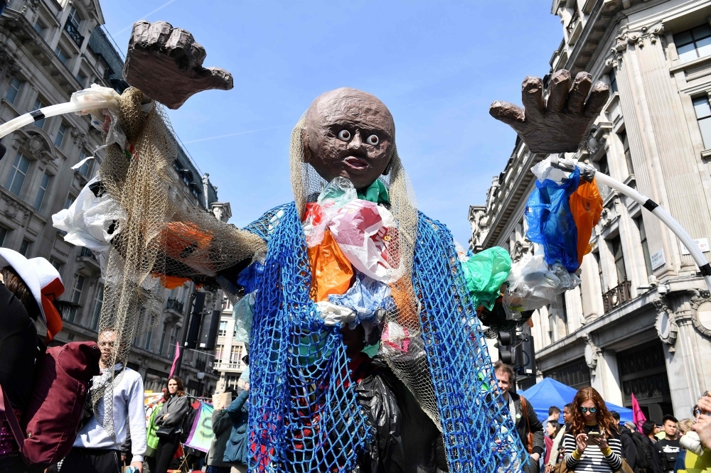 Environmental protesters from the Extinction Rebellion group Oxford Circus as they take part in a demonstration at the junction of Oxford Street and Regent Street in London on Monday. — AFP