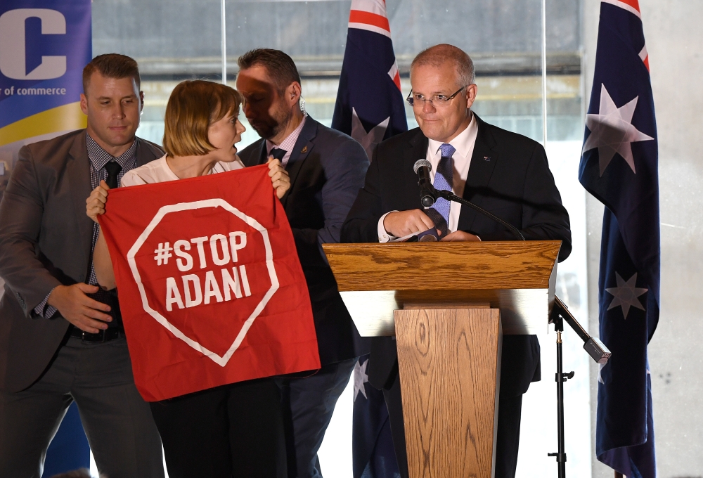 A Stop Adani protestor is removed from the stage where Australian Prime Minister Scott Morrison was making a speech at the Valley Chamber of Commerce business luncheon in Brisbane, Australia, in this April 8, 2019 file photo. — Reuters