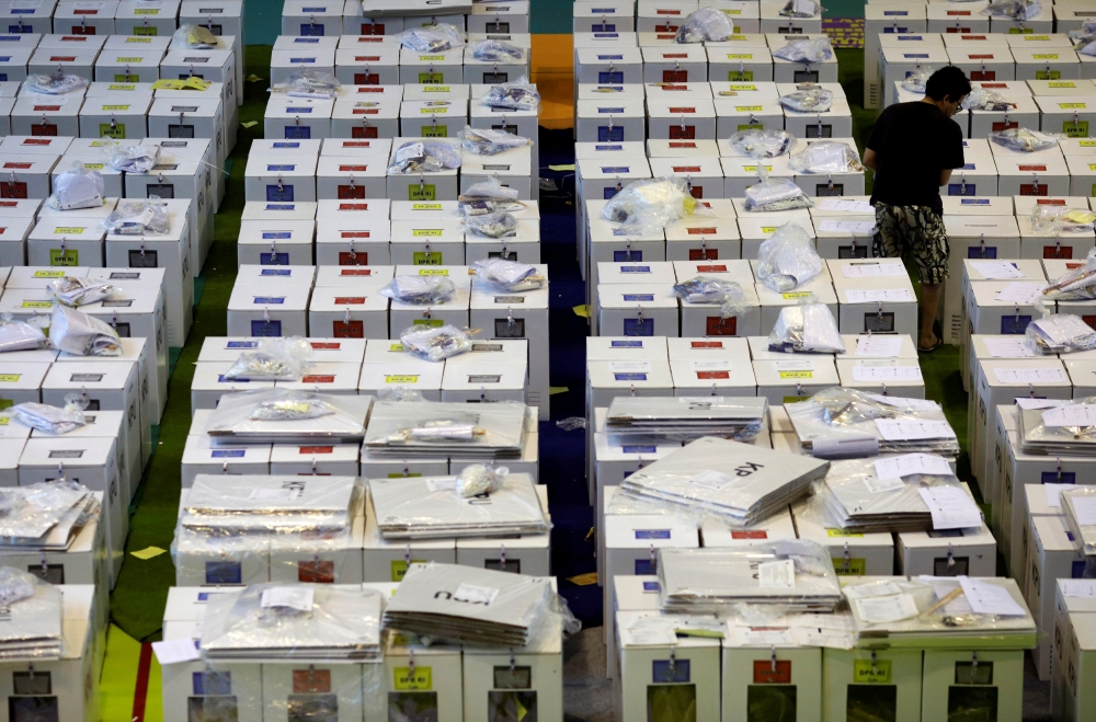 A worker prepares election materials to be distributed to polling stations at a sports hall in Jakarta, Indonesia, on Tuesday. — Reuters