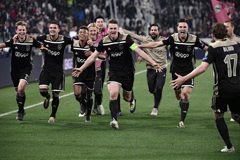 Ajax players celebrate after defeating Juventus during the UEFA Champions League quarterfinal second leg match at the Juventus Stadium in Turin Tuesday. — AFP