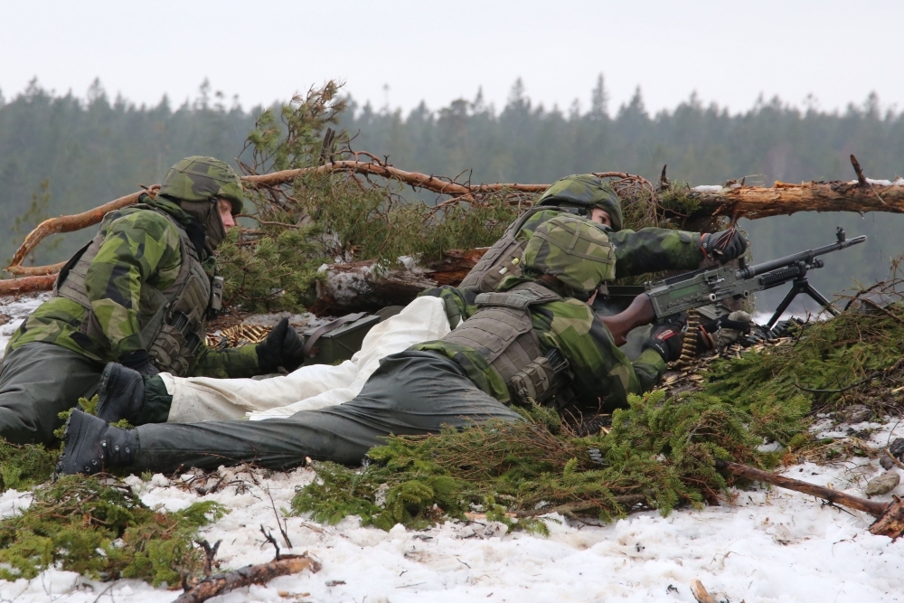 Soldiers from the Swedish Army’s Gotland regiment load a machine gun on a range on the island of Gotland, Sweden, in this Feb. 5, 2019 file photo. — AFP