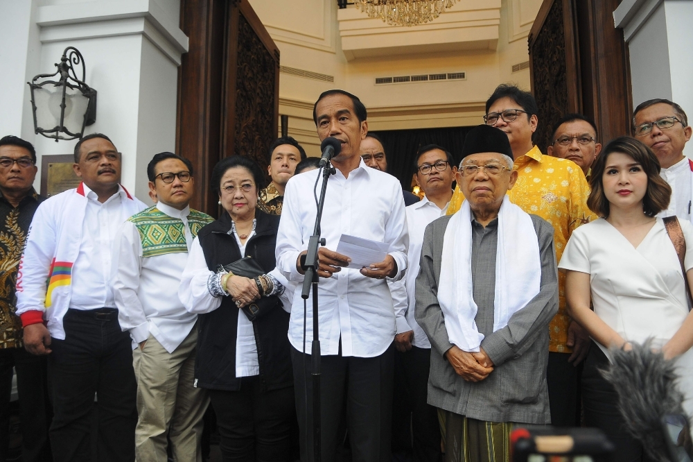 Indonesian President Joko Widodo (center) and his running mate Ma'ruf Amin (centre right) hold a press conference in Jakarta, Thursday. Authorities have warned against unrest as a firebrand ex-general rejected unofficial election results that appeared to hand President Widodo another term as leader of the world's third-biggest democracy. — AFP 