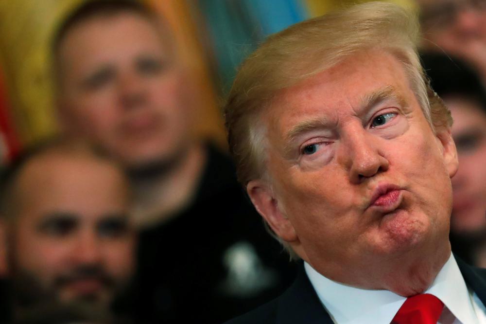 US President Donald Trump reacts as he speaks at the Wounded Warrior Project Soldier Ride event after the release of Special Counsel Robert Mueller's report, in the East Room of the White House in Washington, Thursday. — Reuters