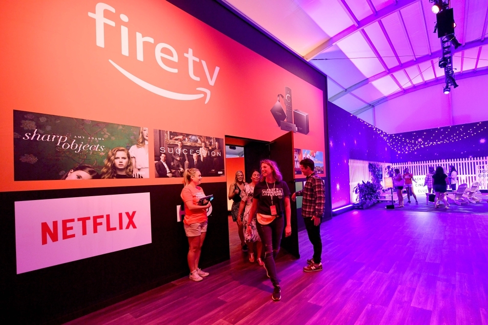 In this file photo guests attend Amazon Fire TV'S 'Fast Forward To The Future' Installation Media Preview during Comic-Con International 2018 in San Diego, California. Amazon and Google announced on Thursday they had agreed to allow each other's streaming media applications to work on their platforms, ending a spat over video between the tech giants. The companies said in a statement that the official YouTube apps will be available on Amazon's Fire TV in the coming months, allowing users of the Amazon platform to access the music videos, movies, shows and other content from the Google-owned service. — AFP