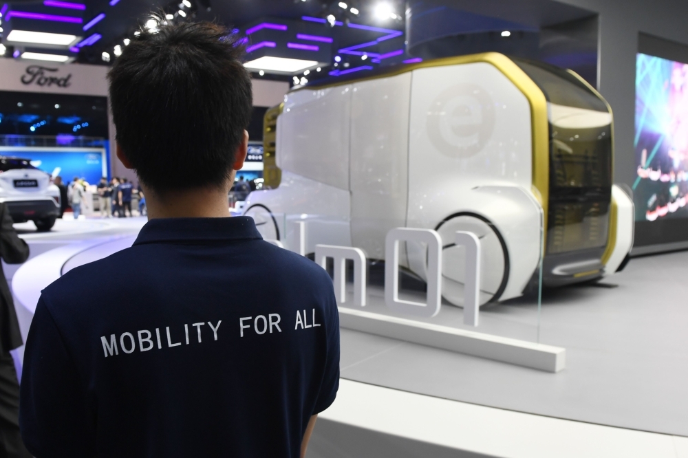 This photo shows a Toyota staff member looking at a Toyota e-Calm 01 autonomous vehicle at the Shanghai Auto Show in Shanghai. Global automakers are positioning for a brave new world of on-demand transport that will require a car of the future — hyper-connected, autonomous, and shared — and China may become the concept's laboratory. — AFP