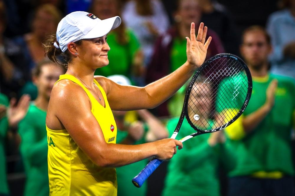 Ashleigh Barty of Australia celebrates her victory over Victoria Azarenka of Belarus during their first round match of the Fed Cup Tennis at the Pat Rafter Arena in Brisbane Saturday. — AFP 