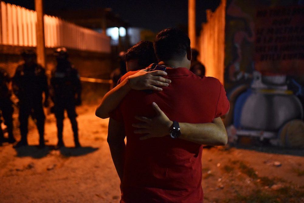 People react at a crime scene where unidentified assailants opened fire at a bar in Minatitlan, in Veracruz state, Mexico, on Friday. — Reuters