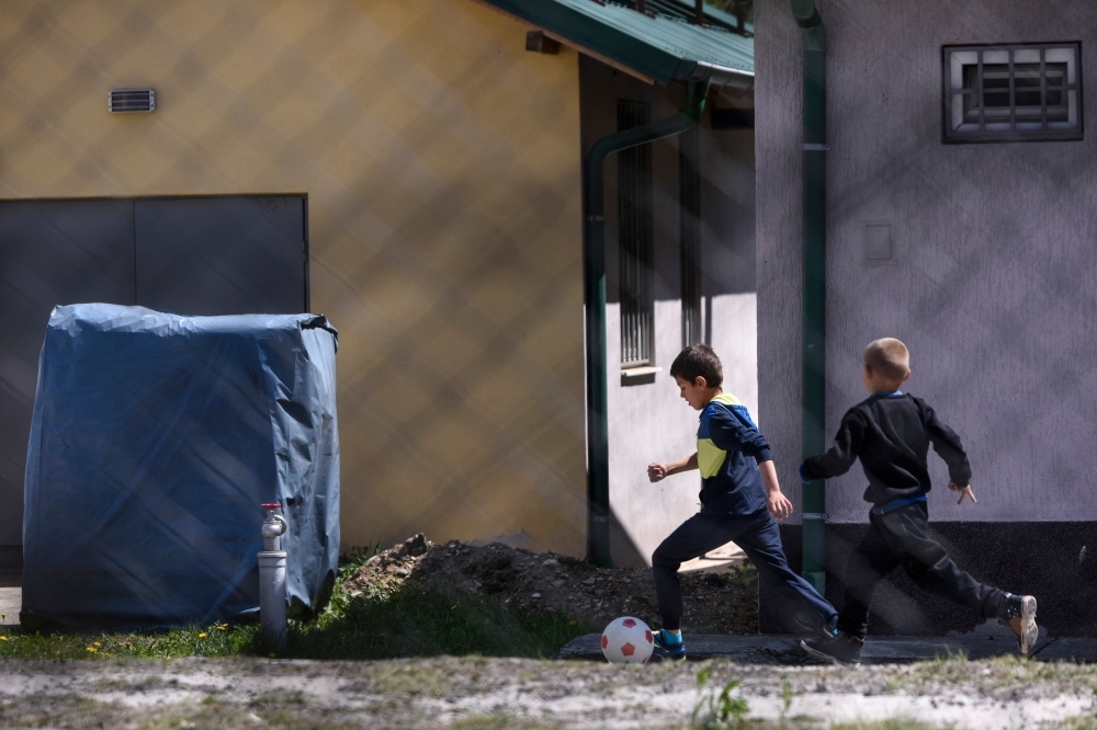 Kosovar children returned from Syria play in the compound of the foreign detention center in the village of Vranidoll, Kosovo, on Saturday. — AFP