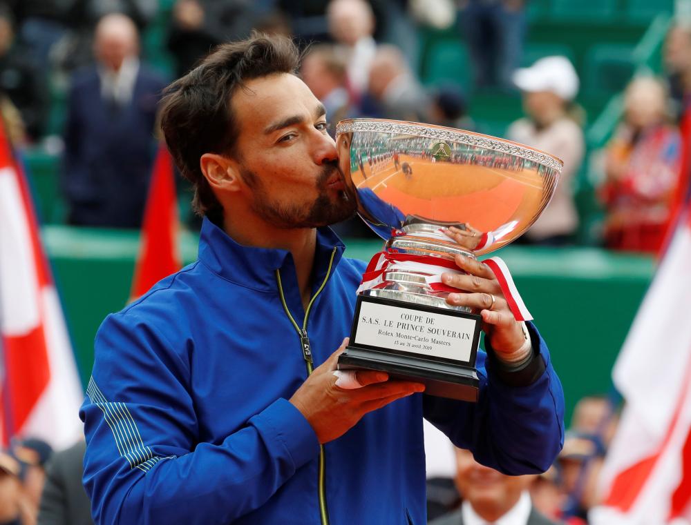 Italy's Fabio Fognini celebrates with the trophy after winning the final against Serbia's Dusan Lajovic at the Monte Carlo Masters Sunday. — Reuters