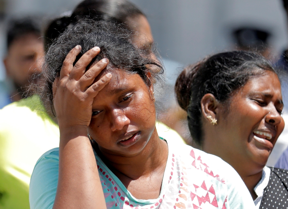 Relatives of victims react at a police mortuary in Colombo on Monday, a day after bomb blasts ripped through churches and luxury hotels on Easter. — Reuters