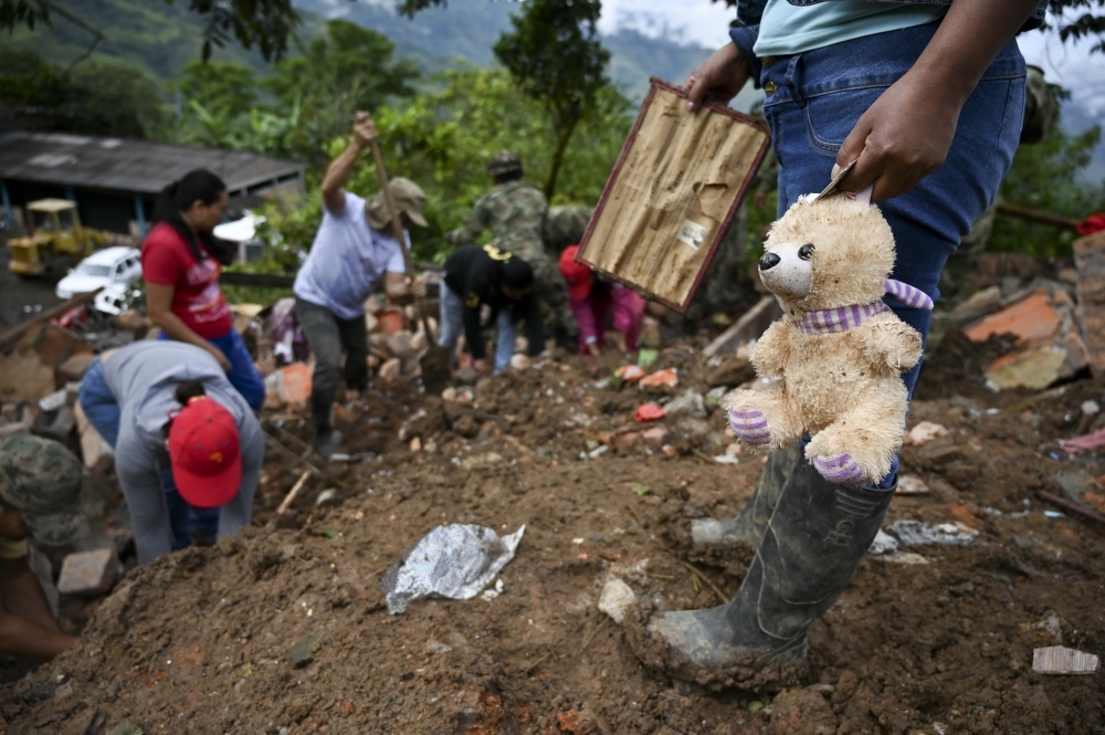 Rescue workers and locals search for victims after a landslide in Rosas, Valle del Cauca department, in southwestern Colombia, on Monday. — AFP