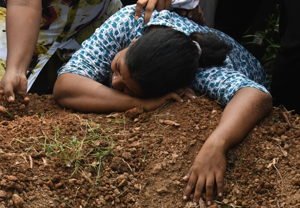 A Sri Lankan woman cries during a burial service for a bomb blast victim in a cemetery in Colombo on Tuesday, two days after a series of bomb attacks targeting churches and luxury hotels in Sri Lanka. — AFP