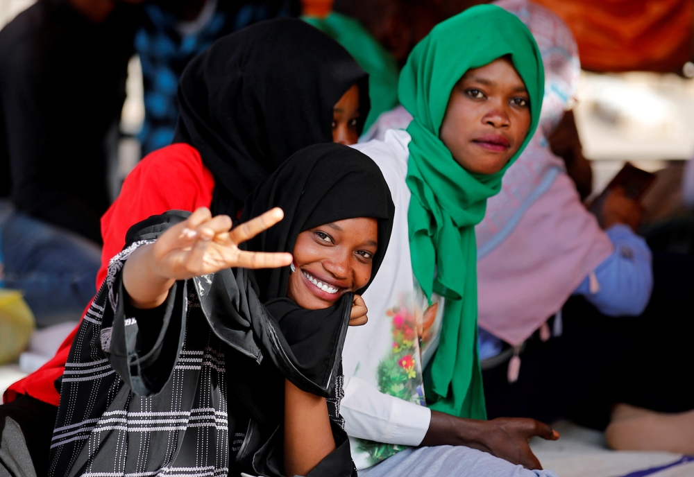 A protester makes a victory sign during a demonstration in front of the Defense Ministry in Khartoum. — Reuters