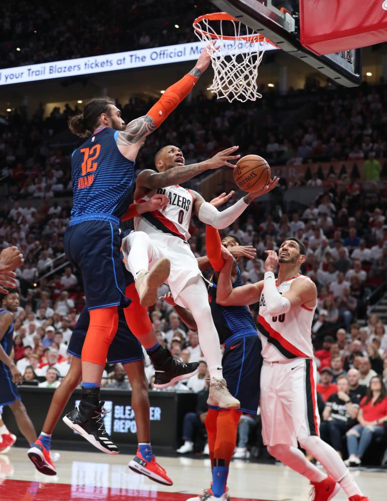 Oklahoma City Thunder’s center Steven Adams (L) defends Portland Trail Blazers’ guard Damian Lillard during Game 5 of the first round of the 2019 NBA Playoffs at Moda Center in Portland Tuesday. — Reuters