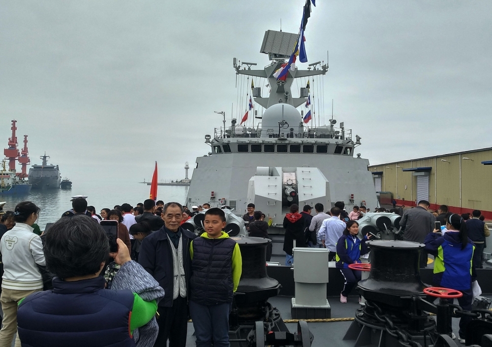 People visit China’s guided-missile frigate Rizhao during a public open day in Qingdao in China’s eastern Shandong province on Wednesday. — AFP