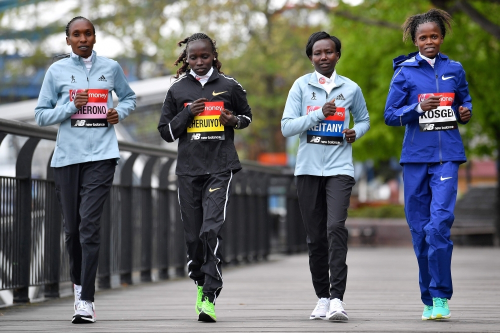 Women's elite runners Kenya's Gladys Cherono (L), Kenya's Vivian Cheruiyot (2L), Kenya's Mary Keitany (2R) and Kenya's Brigid Kosgei pose during a photocall for the London Marathon at Tower Bridge in central London on Thursday. — AFP