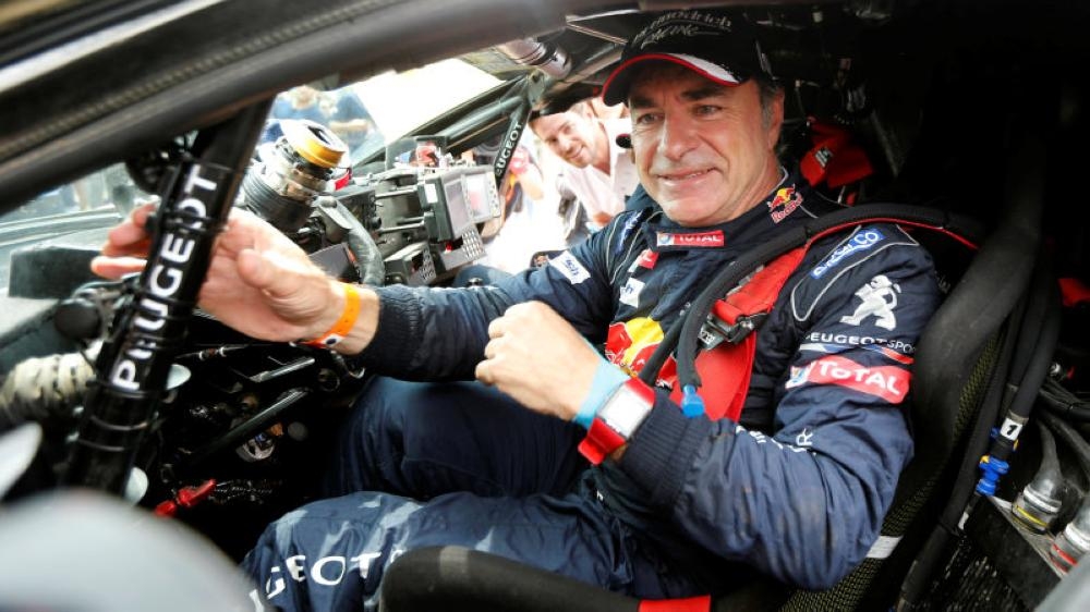 Carlos Sainz of Spain celebrates after winning Dakar rally in this file photo. Sainz said he looked forward to tackling the dunes and deserts of Saudi Arabia next year as Dakar Rally organizers presented the 'third chapter' of their endurance event on Thursday. _ Reuters