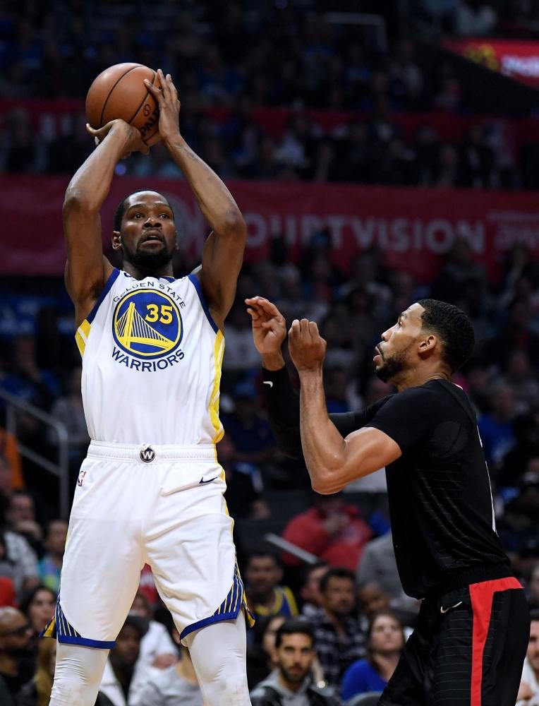 Kevin Durant of the Golden State Warriors takes a shot in front of Garrett Temple of the LA Clippers during Game 6 of Round One of the 2019 NBA Playoffs at Staples Center in Los Angeles Friday. — AFP 
