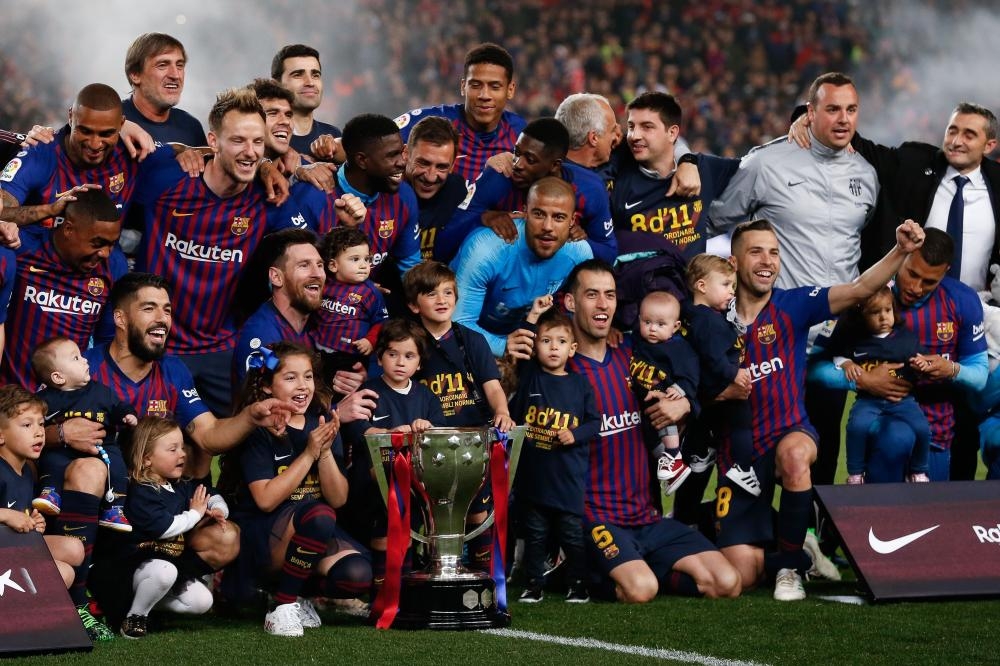 Barcelona players celebrate with the La Liga trophy after winning the club's 26th league title at the end of the Spanish League match against Levante at the Camp Nou Stadium in Barcelona Saturday. — AFP