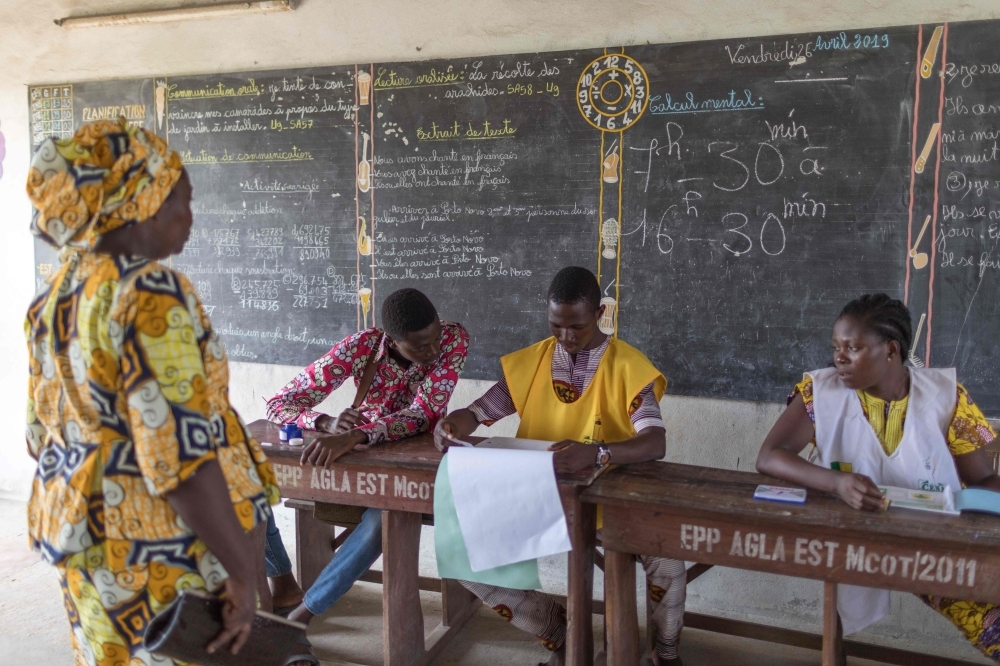 A woman arrives to vote at the Agla East State primary school in Cotonou on Sunday. — AFP