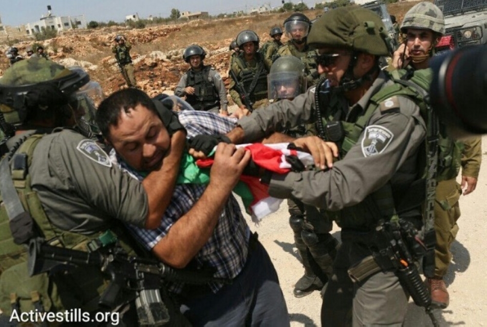 Israeli soldiers beating a Palestinian before arresting him in the occupied West Bank. — Courtesy photo