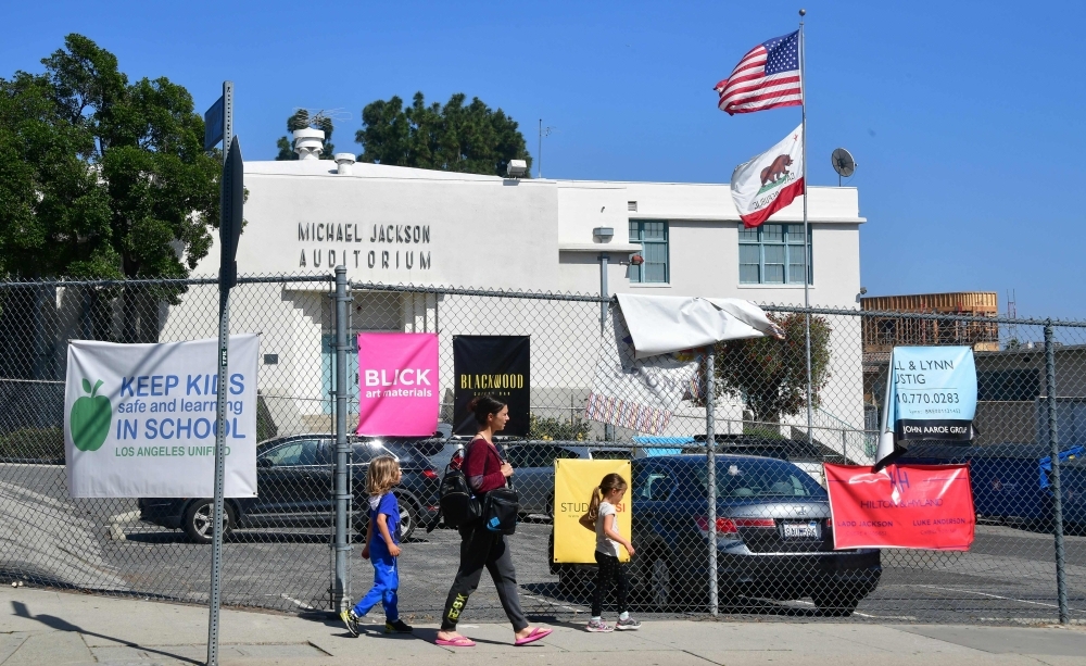 Pedestrians walk past the Michael Jackson Auditorium at Gardner Street Elementary school in Hollywood, California. — AFP
