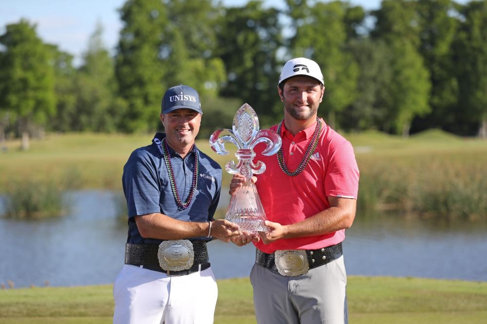 Jon Rahm of Spain and Ryan Palmer of the US pose with the trophy after winning during the Zurich Classic at TPC Louisiana in Avondale Sunday. — AFP 