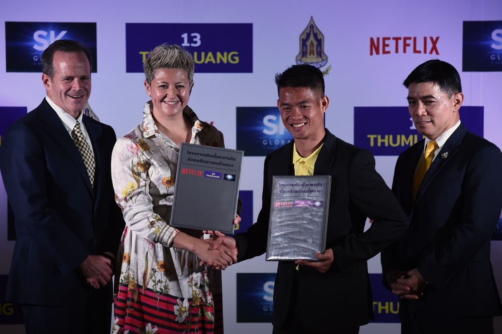 (From L to R) SK Global Entertainment/Ivanhoe Pictures president of international productions Michael Hogan, Netflix director of international originals Erika North, 'Wild Boars' football team coach Ekkapol Chantawong and Thai army Lieutenant-General Werachon Sukondhapatipak pose during a press conference in Bangkok on Tuesday regarding a Netflix series about the rescue of the team from the Tham Luang cave. — AFP