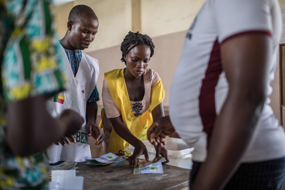 Polling officials check ballots before voting at a polling station during the elections for a new parliament in Cotonou in this April 28, 2019 file photo. — AFP