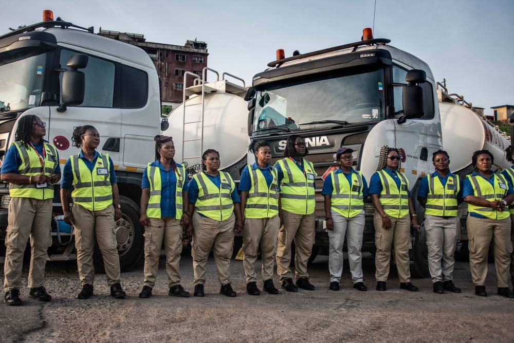 Female truck drivers stand at the Ladybird Logistics meeting point before the start of the workday in Takoradi, western Ghana. AFP