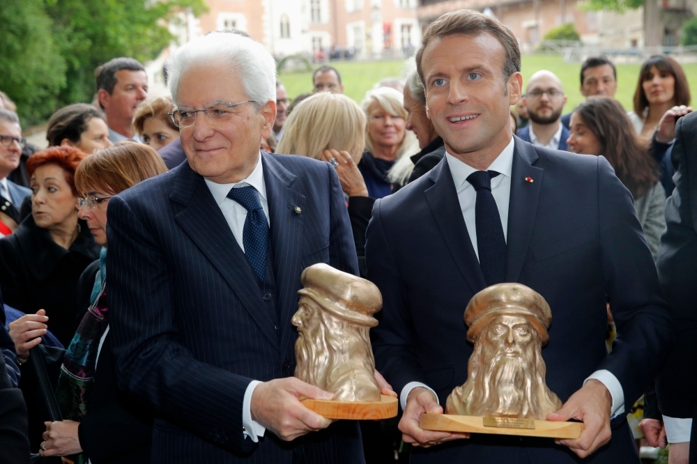 Italian President Sergio Mattarella, left, and French President Emmanuel Macron hold busts of Italian renaissance painter and scientist Leonardo da Vinci during a visit at the Chateau du Clos Luce, as part of a commemoration of the 500th anniversary of his death, in Amboise, central France, on Thursday. — AFP