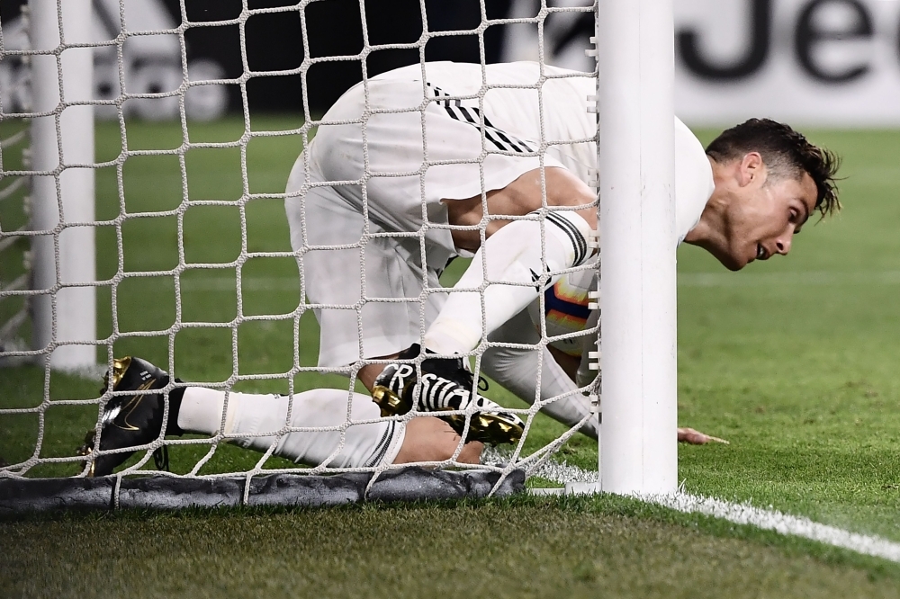 Juventus' Portuguese forward Cristiano Ronaldo falls after scoring a goal during the Italian Serie A football match Juventus vs Torino on Friday at the 'Allianz stadium' in Turin. — AFP