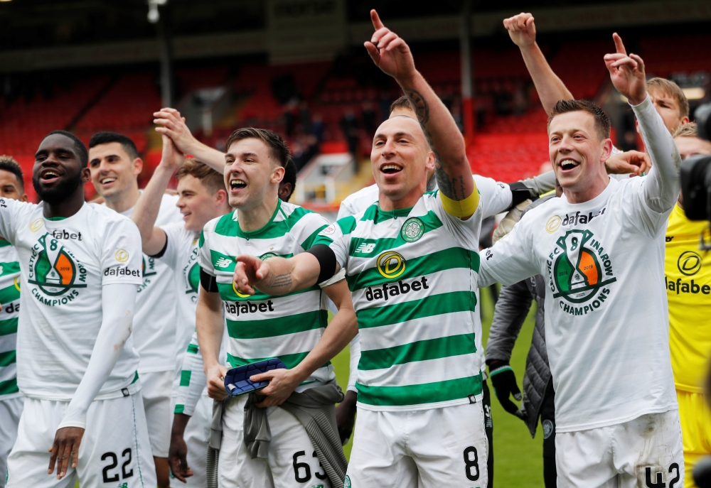Celtic's Scott Brown, Kieran Tierney and teammates celebrate winning the league after beating Aberdeen 3-0 in the Scottish Premiership at the Pittodrie Stadium, Aberdeen, Britain, on Saturday. — Reuters 